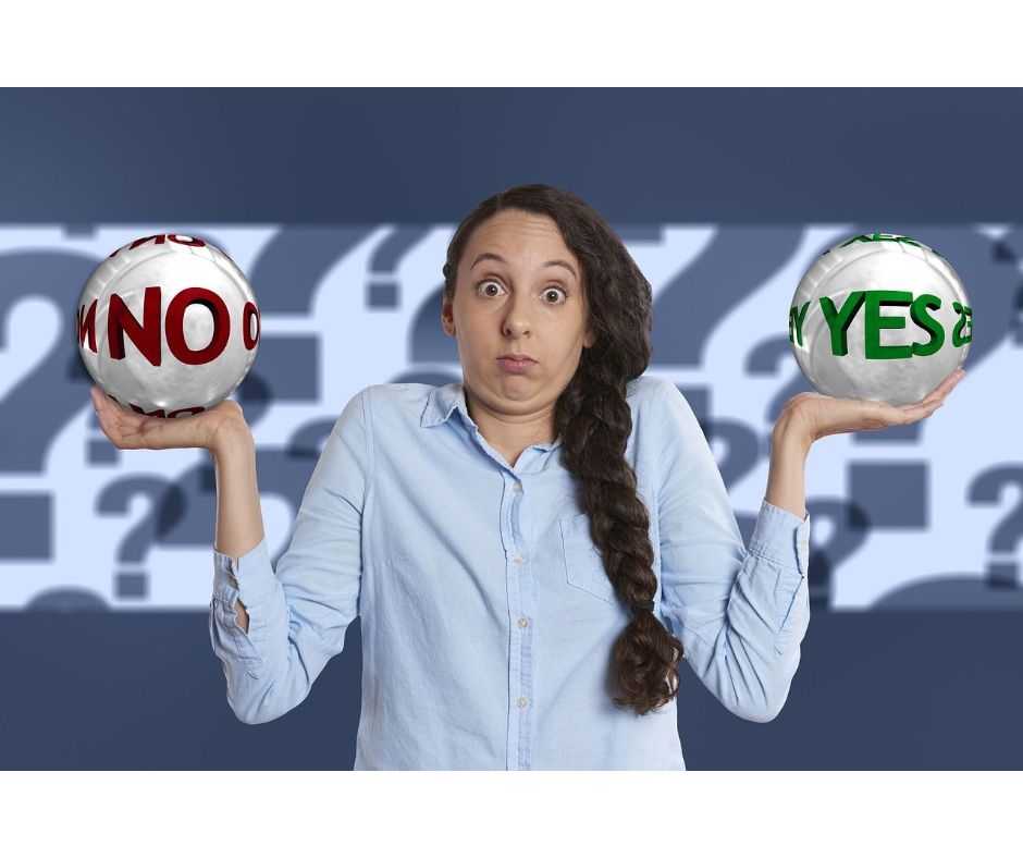 Women holding two balls labelled No and Yes and looking uncertain which to choose. Source: DepositPhotos.com